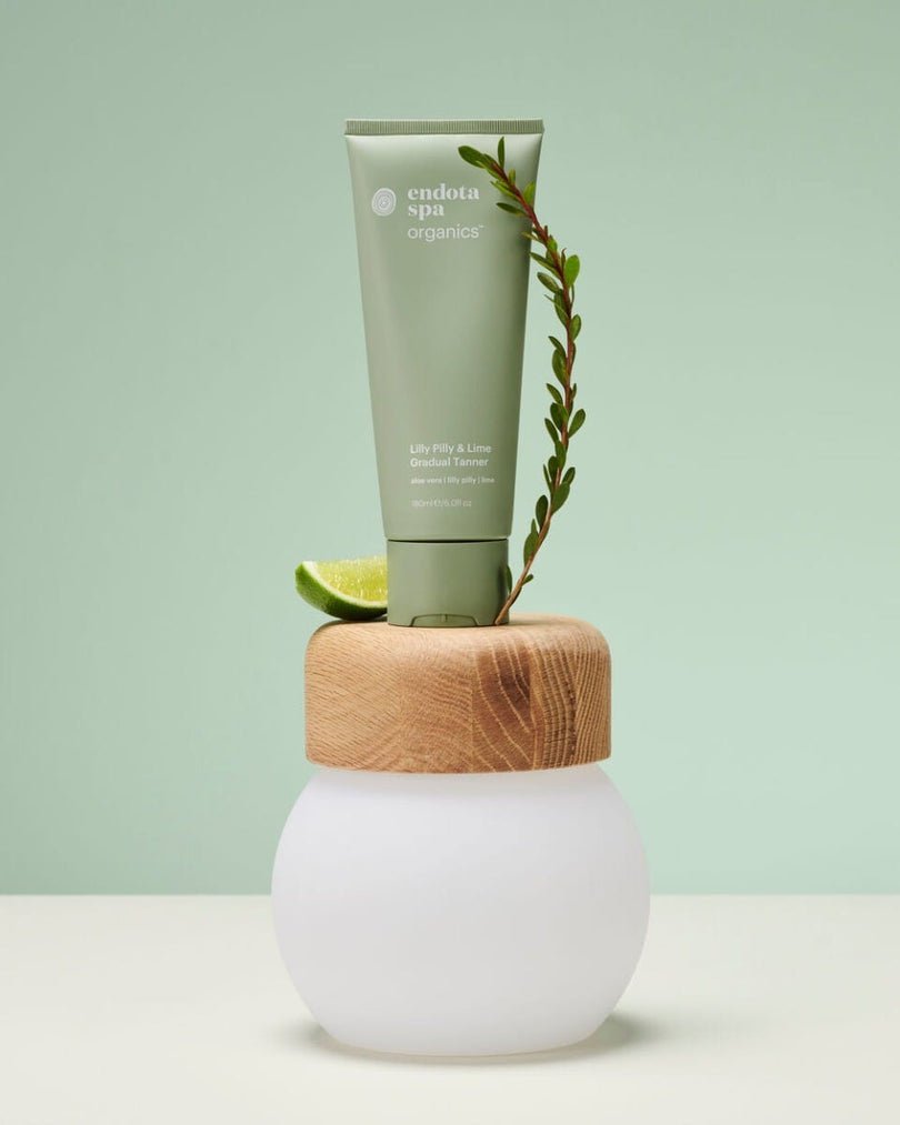 endota Organics Lilly Pilly and Lime Gradual Tanner 180ml manufacturer photograph with lime and botanical stem