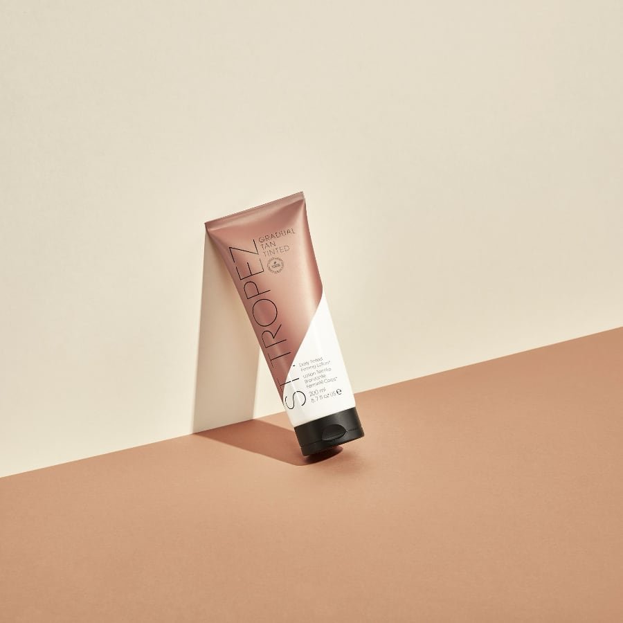 St. Tropez Gradual Tan Tinted Daily Firming Lotion 200ml tube in manufacturer product scene